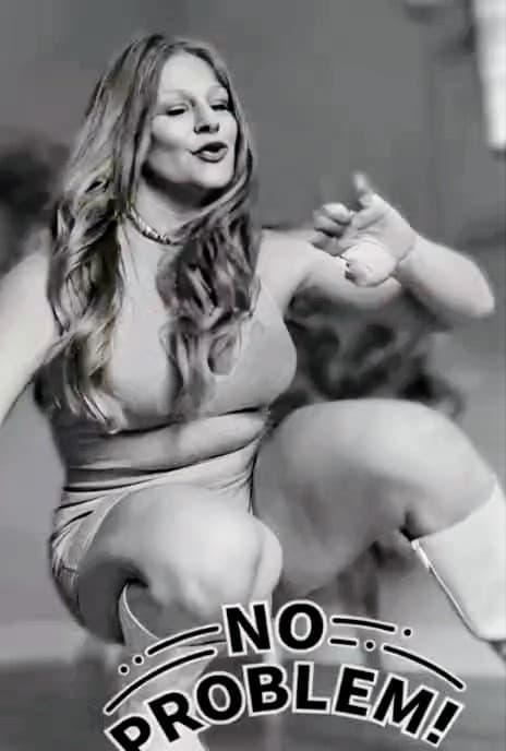 Long-haired woman gesturing while crouching, with 'NO PROBLEM!' text overlay in black and white.